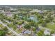 An aerial view of the home near a pond, lush landscaping, and convenient access to shopping and restaurants at 614 S Amelia Ave, Deland, FL 32724