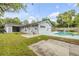 Backyard with a pool, patio, lawn, and privacy fence at 614 S Amelia Ave, Deland, FL 32724