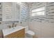 Nicely remodeled bathroom with bright window and unique fish wallpaper at 614 S Amelia Ave, Deland, FL 32724