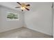 Bright bedroom featuring polished terrazzo floors and a window view at 614 S Amelia Ave, Deland, FL 32724