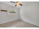 Cozy bedroom featuring polished terrazzo floors and a bright window at 614 S Amelia Ave, Deland, FL 32724