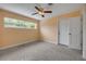 Cozy bedroom featuring terrazzo floors and a classic ceiling fan at 614 S Amelia Ave, Deland, FL 32724