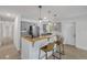 Well-designed kitchen with gray cabinets, a breakfast bar, and modern pendant lighting fixtures to set the mood at 614 S Amelia Ave, Deland, FL 32724
