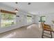 Inviting living area featuring terrazzo floors, white walls, and views of the front yard through large windows at 614 S Amelia Ave, Deland, FL 32724