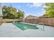 In-ground pool surrounded by a wood fence in the backyard of this home at 614 S Amelia Ave, Deland, FL 32724