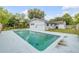 Backyard view with a private pool, patio, and privacy fence at 614 S Amelia Ave, Deland, FL 32724