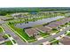 Aerial view of homes, a pond, and amenities in a well-planned community with lush landscaping and serene water views at 6348 Mossy Oak Rd, St Cloud, FL 34771
