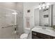 Modern bathroom featuring a glass-enclosed shower, toilet, and vanity with a sink and chrome fixtures at 6348 Mossy Oak Rd, St Cloud, FL 34771