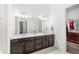 This large bathroom includes a double sink vanity, and an entry to the walk-in closet at 6348 Mossy Oak Rd, St Cloud, FL 34771