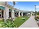 Clubhouse exterior with outdoor seating, artificial turf, and lush landscaping at 6348 Mossy Oak Rd, St Cloud, FL 34771