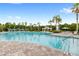 Resort-style community pool with clear water, palm trees, lounge chairs and lush landscaping for relaxation at 6348 Mossy Oak Rd, St Cloud, FL 34771