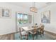 The dining area offers natural light and a calming lake view for enjoying meals with Gathering and friends at 6348 Mossy Oak Rd, St Cloud, FL 34771
