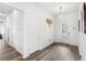 This bright foyer includes a decorative glass door and durable wood-look flooring at 6348 Mossy Oak Rd, St Cloud, FL 34771