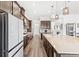 Spacious kitchen with stainless appliances, ample counter space, and stylish light fixtures at 6348 Mossy Oak Rd, St Cloud, FL 34771