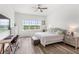 The main bedroom features a ceiling fan, water view, and includes a workspace and seating area at 6348 Mossy Oak Rd, St Cloud, FL 34771