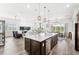 Open floorplan with seamless transitions between the kitchen, living, and dining areas at 6348 Mossy Oak Rd, St Cloud, FL 34771
