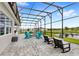Spacious screened patio with grey brick pavers, fire pit, pond view at 6348 Mossy Oak Rd, St Cloud, FL 34771