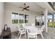 Covered patio with ceiling fans and outdoor dining for entertaining at 6348 Mossy Oak Rd, St Cloud, FL 34771