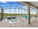 Screened-in lanai with splash pool and lake view, perfect for relaxation and entertainment at 6348 Mossy Oak Rd, St Cloud, FL 34771