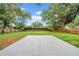 Large, expansive backyard surrounded by a wooden fence and trees at 6505 Dorchester Rd, Lakeland, FL 33809