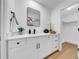 Bathroom features a modern vanity with a stone countertop and a walk-in closet at 6505 Dorchester Rd, Lakeland, FL 33809