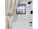 Bathtub with tiled walls, showerhead, and window at 6505 Dorchester Rd, Lakeland, FL 33809