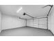 Spacious garage with painted floors, white doors, and ample lighting at 6505 Dorchester Rd, Lakeland, FL 33809
