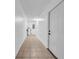 Hallway with white walls and tile floor at 6505 Dorchester Rd, Lakeland, FL 33809