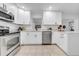 Bright kitchen features stainless steel appliances, stone countertops, and white cabinetry at 6505 Dorchester Rd, Lakeland, FL 33809