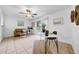 Cozy living room features a ceiling fan, sliding glass doors and a decorative accent wall at 6505 Dorchester Rd, Lakeland, FL 33809