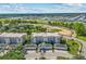 Overhead view showcasing the condo community's buildings, parking, landscaping, and surrounding areas at 7509 Mourning Dove Cir # 302, Reunion, FL 34747