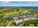 Aerial view of property highlighting the location near a golf course and other neighborhoods at 7509 Mourning Dove Cir # 302, Reunion, FL 34747