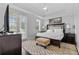 A bright bedroom with a king bed, dark wood furniture, and carpet at 7509 Mourning Dove Cir # 302, Reunion, FL 34747
