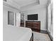 A Primary bedroom with a built-in dresser, luxury vinyl floors, and neutral colored walls at 7509 Mourning Dove Cir # 302, Reunion, FL 34747