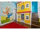 A bedroom with a custom-built bunk bed and bright, colorful wall decorations at 7509 Mourning Dove Cir # 302, Reunion, FL 34747