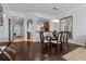 A dining room featuring wood floors, seating for six, and modern lighting fixture at 7509 Mourning Dove Cir # 302, Reunion, FL 34747