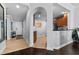 Hallway leading to kitchen with a dark countertop and wooden cabinets and entry and hallway art at 7509 Mourning Dove Cir # 302, Reunion, FL 34747