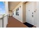 Welcoming hallway featuring a door with a secure lock, exterior lighting, and a glimpse of outdoor scenery at 7509 Mourning Dove Cir # 302, Reunion, FL 34747