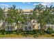Charming multi-story building featuring well-manicured landscaping and inviting balconies at 7509 Mourning Dove Cir # 302, Reunion, FL 34747