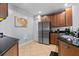 Charming kitchen featuring wooden cabinets, dark countertops, a stainless steel refrigerator, and tiled flooring at 7509 Mourning Dove Cir # 302, Reunion, FL 34747