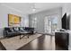 Inviting living room featuring hardwood floors, stylish furniture, a ceiling fan, and sliding glass doors at 7509 Mourning Dove Cir # 302, Reunion, FL 34747