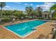 Inviting community pool area with ample seating and well-maintained landscaping at 7509 Mourning Dove Cir # 302, Reunion, FL 34747