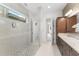 Bright bathroom featuring a glass walk-in shower, granite countertops, and sleek cabinetry at 8106 Mabury Ln, Orlando, FL 32832