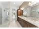 Elegant bathroom with dual vanities, granite countertops, decorative tile and glass-enclosed shower at 8106 Mabury Ln, Orlando, FL 32832