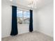 Bright bedroom with neutral carpet, large window with dark curtains and contemporary lighting fixture at 8106 Mabury Ln, Orlando, FL 32832