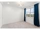Spacious bedroom with plush carpeting, bright windows and dark curtains at 8106 Mabury Ln, Orlando, FL 32832