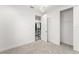 A carpeted bedroom with a walk-in closet, and modern light fixture at 8106 Mabury Ln, Orlando, FL 32832