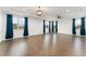 Spacious bonus room with hardwood floors, tray ceiling, and large windows for natural light at 8106 Mabury Ln, Orlando, FL 32832