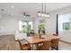 Open-concept dining and living space with wood floors, contemporary lighting, and ample seating at 8106 Mabury Ln, Orlando, FL 32832