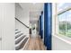 Inviting home hallway with wood floors, large windows, and staircase leading to the upper level at 8106 Mabury Ln, Orlando, FL 32832